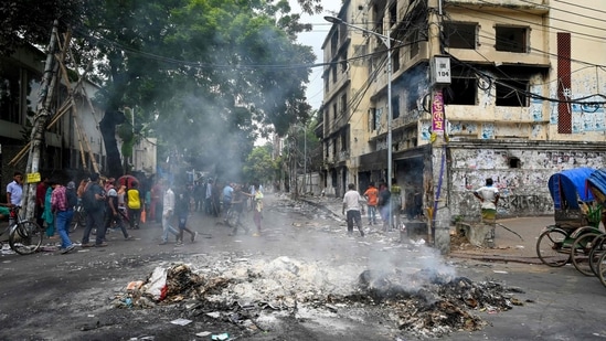 Smoke billows near burnt Awami League party office as anti-government protestors set fire in Dhaka on August 6, 2024, after former prime minister Sheikh Hasina fled the country. (Photo by Munir Uz Zaman / AFP)(AFP)