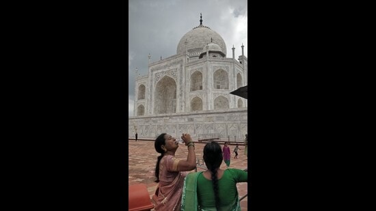 Tourists consuming water before moving for white marble platform of Taj on Tuesday. (Ranvijay Singh)