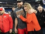 FILE - Kansas City Chiefs tight end Travis Kelce and Taylor Swift walk together after an AFC Championship NFL football game between the Chiefs and the Baltimore Ravens, Jan. 28, 2024, in Baltimore.. Taylor Swift, who is holding concerts in Japan, will make it in time for the Super Bowl to see her partner and football superstar Travis Kelce play. (AP Photo/Julio Cortez, File)
