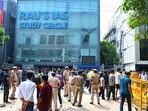 Security outside Rau's Study Circle following flooding that left three students dead. (HT PHOTO) Security outside Rau's Study Circle following flooding that left three students dead. (HT PHOTO)