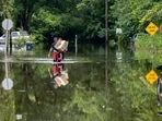 Savannah Fire Advanced Firefighters Andrew Stevenson, front, and Ron Strauss carry food to residents in the Tremont Park neighborhood that where stranded in flooding from Tropical Storm Debby, Tuesday, Aug. 6, 2024, in Savannah, Ga. (AP Photo/Stephen B. Morton) Savannah Fire Advanced Firefighters Andrew Stevenson, front, and Ron Strauss carry food to residents in the Tremont Park neighborhood that where stranded in flooding from Tropical Storm Debby, Tuesday, Aug. 6, 2024, in Savannah, Ga. (AP Photo/Stephen B. Morton)