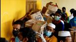 Volunteers carry boxes of rations to a relief camp, after landslides hit several villages in Wayanad district, in Meppadi, in the southern state of Kerala (REUTERS) Volunteers carry boxes of rations to a relief camp, after landslides hit several villages in Wayanad district, in Meppadi, in the southern state of Kerala (REUTERS)