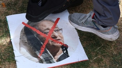 Protesters step on a poster of Sheikh Hasina. (Reuters Photo)