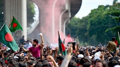 Anti-government protestors wave Bangladesh's national flag as they celebrate at Shahbag area, near Dhaka university in Dhaka on August 5, 2024. (AFP)