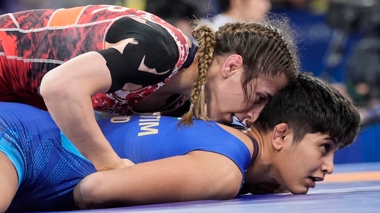 Turkey's Zeynep Yetgil and India's Antim Antim, right, compete in the round of 16 of the women's freestyle 53kg wrestling match, at Champ-de-Mars Arena, during the 2024 Summer Olympics(AP)