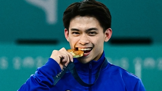 Carlo Yulo's historic victory at the 2024 Paris Olympics landed him a long list of rewards including a $414k home and a lifetime supply of ramen (AFP)