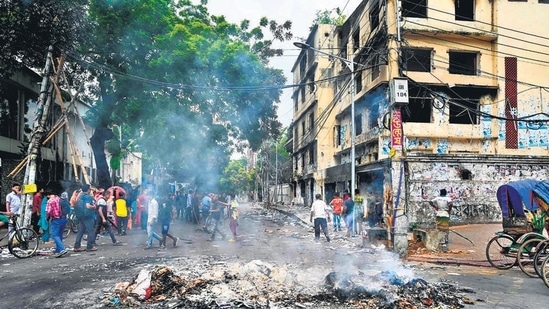 Smoke billows near burnt Awami League party office as anti-government protestors set fire in Dhaka on Tuesday. (AFP)