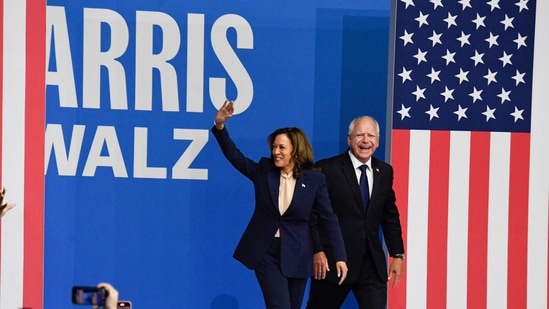 TOPSHOT - US Vice President and 2024 Democratic presidential candidate Kamala Harris and her running mate Minnesota Gorvernor Tim Walz greet their supporters as they arrive at Temple University's Liacouras Center in Philadelphia, Pennsylvania, August 6, 2024, on the first day of their "Battleground State Tour". (Photo by MATTHEW HATCHER / AFP)(AFP)