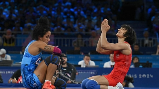 India's Vinesh Vinesh (R) reacts her win over Cuba's Yusneylis Guzman Lopez (L) in their women's freestyle 50kg wrestling semi-final match. (AFP)