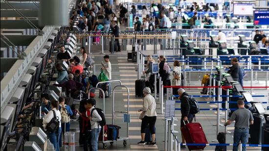 Travellers at Vancouver International Airport in Vancouver, British Columbia, Canada. (Bloomberg)