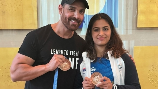 John Abraham meets Olympic medalist Manu Bhaker; netizens don't like him touching her medal