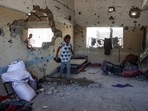 A young Palestinian woman checks the damage inside a classroom at the al-Zahra school used as a refuge by displaced Palestinians. (AFP) A young Palestinian woman checks the damage inside a classroom at the al-Zahra school used as a refuge by displaced Palestinians. (AFP)
