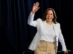 U.S. Vice President and Democratic presidential candidate Kamala Harris waves at the stage during a campaign rally with her newly-chosen vice presidential running mate, Minnesota Governor Tim Walz, at Detroit Metropolitan Wayne County Airport in Romulus, Michigan, U.S.,