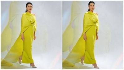 Her gown is a stunning chartreuse color, featuring an asymmetric one-shoulder neckline, an intricate front drape, a column skirt, and a long cape in tendershoots heavy crepe and satin back crepe. (Instagram) Her gown is a stunning chartreuse color, featuring an asymmetric one-shoulder neckline, an intricate front drape, a column skirt, and a long cape in tendershoots heavy crepe and satin back crepe. (Instagram)