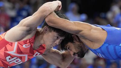 Japan's Rei Higuchi (L) beat India's Aman in the men's freestyle 57kg semi-final. (AP) Japan's Rei Higuchi (L) beat India's Aman in the men's freestyle 57kg semi-final. (AP)