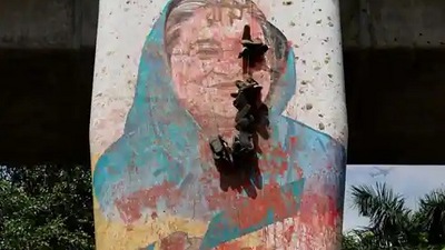 A view shows a mural of former Bangladeshi Prime Minister Sheikh Hasina vandalised by protesters A view shows a mural of former Bangladeshi Prime Minister Sheikh Hasina vandalised by protesters
