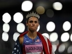 Gold medallist US' Sydney Mclaughlin-Levrone wears a crown as she celebrates winning the women's 400m hurdles final of the athletics event 