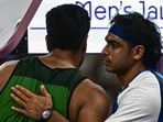 India's Neeraj Chopra (R) congratulates Pakistan's Arshad Nadeem after the men's javelin throw final of the athletics event at the Paris 2024 Olympic Games at Stade de France in Saint-Denis, north of Paris, on August 8, 2024