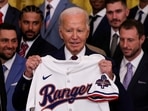 U.S. President Joe Biden receives an honorary jersey from Texas Rangers Manager Bruce Bochy (not pictured) as he welcomes the 2023 World Series champion Texas Rangers in the East Room at the White House in Washington, U.S., August 8, 2024. REUTERS/Umit Bektas     TPX IMAGES OF THE DAY