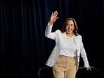 U.S. Vice President and Democratic presidential candidate Kamala Harris waves at the stage during a campaign rally with her newly-chosen vice presidential running mate, Minnesota Governor Tim Walz, at Detroit Metropolitan Wayne County Airport in Romulus, Michigan, U.S.,