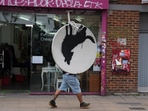Man making off with the stolen Banksy piece Man making off with the stolen Banksy piece