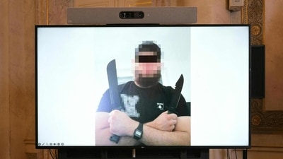 A screen displays a photo of a man arrested in connection with an Islamist attack plot that caused the cancellation of the Vienna leg of a tour by Taylor Swift. (AFP) A screen displays a photo of a man arrested in connection with an Islamist attack plot that caused the cancellation of the Vienna leg of a tour by Taylor Swift. (AFP)