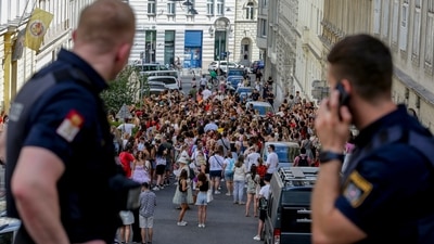 Austrian police officers watch swifts gathering in the city centre in Vienna on Thursday, Aug.8, 2024. Organizers of three Taylor Swift concerts in the stadium in Vienna this week called them off on Wednesday after officials announced arrests over an apparent plot to launch an attack on an event in the Vienna area such as the concerts. (AP Photo/Heinz-Peter Bader) (AP) Austrian police officers watch swifts gathering in the city centre in Vienna on Thursday, Aug.8, 2024. Organizers of three Taylor Swift concerts in the stadium in Vienna this week called them off on Wednesday after officials announced arrests over an apparent plot to launch an attack on an event in the Vienna area such as the concerts. (AP Photo/Heinz-Peter Bader) (AP)