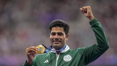 Pakistan’s gold medallist Arshad Nadeem poses for photos at the podium on Friday. (PTI)