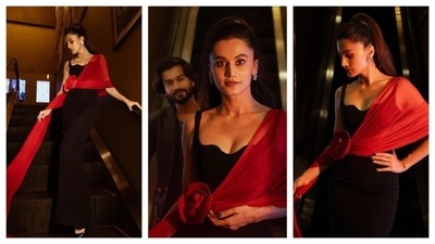 Taapsee Pannu looked rosy in this rose-inspired dress. She wore a black bodycon dress with a sweetheart neckline. The highlight of her dress was the red drape from her shoulder, which bunched at her waist in a big rose and trailed down. The one-shoulder red drape contrasted with the black dress, and radiated with a classy vibe, (Instagram/@bollywoodtellybuzz) Taapsee Pannu looked rosy in this rose-inspired dress. She wore a black bodycon dress with a sweetheart neckline. The highlight of her dress was the red drape from her shoulder, which bunched at her waist in a big rose and trailed down. The one-shoulder red drape contrasted with the black dress, and radiated with a classy vibe, (Instagram/@bollywoodtellybuzz)