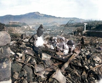 In this black and white AP photo digitally colorized and published in 2020 by Anju Niwata and Hidenori Watanave, a battered religious figure stands witness on a hill above a burn-razed valley at Nagasaki, on Sept. 24, 1945, after the second atomic bomb ever used in warfare was dropped by the U.S. over the Japanese industrial center. (AP) In this black and white AP photo digitally colorized and published in 2020 by Anju Niwata and Hidenori Watanave, a battered religious figure stands witness on a hill above a burn-razed valley at Nagasaki, on Sept. 24, 1945, after the second atomic bomb ever used in warfare was dropped by the U.S. over the Japanese industrial center. (AP)