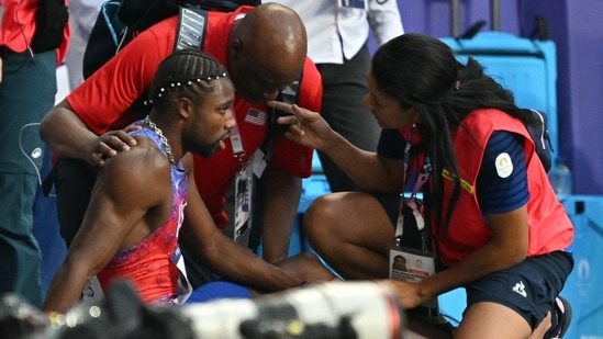 Bronze medallist, US' Noah Lyles receives medical attention after competing in the men's 200m final of the athletics event at the Paris 2024 Olympic Games at Stade de France in Saint-Denis(AFP)