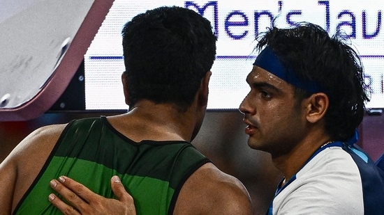 India's Neeraj Chopra (R) congratulates Pakistan's Arshad Nadeem after the men's javelin throw final of the athletics event at the Paris 2024 Olympic Games at Stade de France in Saint-Denis, north of Paris, on August 8, 2024(AFP)