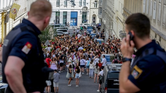 Austrian police officers watch swifts gathering in the city centre in Vienna on Thursday, Aug.8, 2024. Organizers of three Taylor Swift concerts in the stadium in Vienna this week called them off on Wednesday after officials announced arrests over an apparent plot to launch an attack on an event in the Vienna area such as the concerts. (AP Photo/Heinz-Peter Bader)(AP)