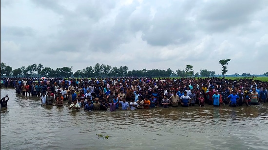 Bangladeshi nationals gather at the international border at Sitalkuchi in Cooch Behar on Friday in an attempt to enter India. (PTI)