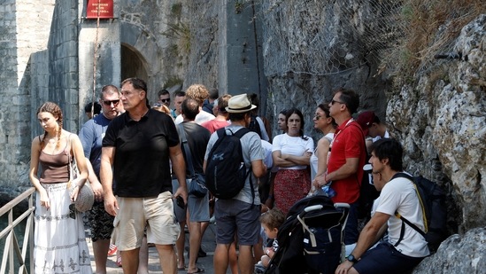 Tourists crowd in front of the Gurdic Gate of the Old Town, amidst concerns about 'over-tourism' in Kotor. (REUTERS)