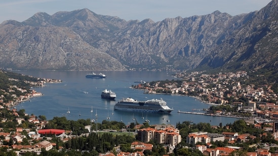 Cruise ships ferrying thousands of daily visitors navigate to dock at the city port amid concerns about 'over-tourism' in Kotor, Montenegro. (REUTERS)