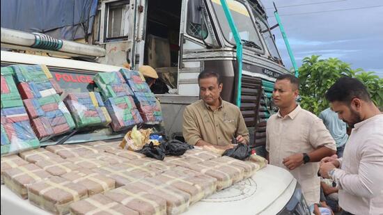 Officials with the drugs after their seizure. (HT Photo)