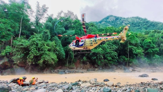 Teams of Special Operations Group and IAF, along with one Cadavar dog being airlifted during a search and rescue operation underway at a landslide-hit area in Wayanad.(PTI)