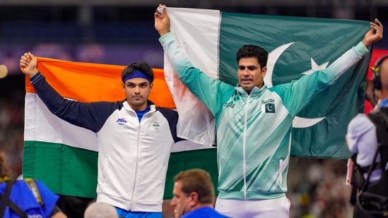 Silver medallist India's Neeraj Chopra and gold medallist Pakistan's Arshad Nadeem celebrate after the men's javelin throw final at the 2024 Summer Olympics, in Paris(PTI)