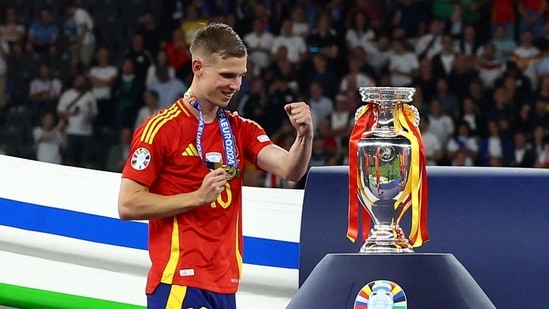 Spain's Dani Olmo celebrates near the trophy after winning the Euro 2024 (REUTERS)