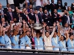 Manchester City's Kevin De Bruyne lifts the trophy as he celebrates with teammates after winning the Community Shield