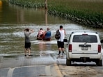 Eric Combs, Maverick Knight and Michelle Knight paddle away as they traverse high water along Canisteo River Road in Canisteo, N.Y., Friday, Aug. 9, 2024, after remnants of Tropical Storm Debby swept through the area. (AP Photo/Craig Ruttle)(AP) Eric Combs, Maverick Knight and Michelle Knight paddle away as they traverse high water along Canisteo River Road in Canisteo, N.Y., Friday, Aug. 9, 2024, after remnants of Tropical Storm Debby swept through the area. (AP Photo/Craig Ruttle)(AP)