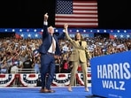Minnesota Governor and Democratic vice presidential candidate Tim Walz (L) gestures alongside US Vice President and Democratic presidential candidate Kamala Harris during a campaign event at Desert Diamond Arena in Glendale, Arizona, on August 9, 2024.