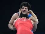 Kyrgyzstan's Aiperi Medet Kyzy (red) wrestles India's Reetika Reetika (blue) in their women's freestyle 76kg wrestling quarter-final match at the Champ-de-Mars Arena during the Paris 2024 Olympic Games, in Paris 