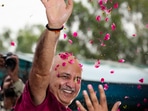 AAP leader Manish Sisodia waves to supporters after being released from Tihar jail 