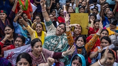 Members of the Bangladeshi Hindu community were seen blocking a major intersection in Dhaka chanting slogans such as "who are we, Bengali Bengali" and holding signs asking for violence against Hindus to stop. (AFP) Members of the Bangladeshi Hindu community were seen blocking a major intersection in Dhaka chanting slogans such as "who are we, Bengali Bengali" and holding signs asking for violence against Hindus to stop. (AFP)