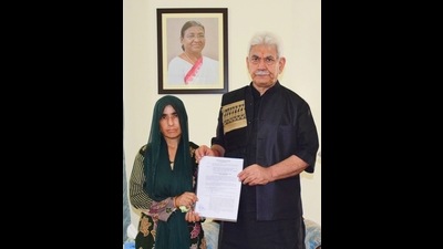J&K lieutenant governor Manoj Sinha, on Saturday, handed over the appointment letter, on compassionate ground, to Renu Sharma, wife of Vijay Kumar, who was killed in Reasi terror attack on June 9 this year, at Raj Bhawan here. (HT Photo) J&K lieutenant governor Manoj Sinha, on Saturday, handed over the appointment letter, on compassionate ground, to Renu Sharma, wife of Vijay Kumar, who was killed in Reasi terror attack on June 9 this year, at Raj Bhawan here. (HT Photo)
