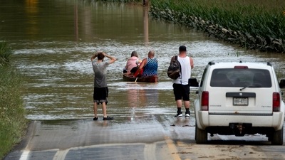 Eric Combs, Maverick Knight and Michelle Knight paddle away as they traverse high water along Canisteo River Road in Canisteo, N.Y., Friday, Aug. 9, 2024, after remnants of Tropical Storm Debby swept through the area. (AP Photo/Craig Ruttle) (AP) Eric Combs, Maverick Knight and Michelle Knight paddle away as they traverse high water along Canisteo River Road in Canisteo, N.Y., Friday, Aug. 9, 2024, after remnants of Tropical Storm Debby swept through the area. (AP Photo/Craig Ruttle) (AP)