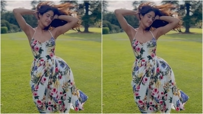In a new video, Janhvi Kapoor embraced spring in a spaghetti strap midi dress. The ivory ensemble is by Dolce & Gabbana and features a colourful floral pattern, a halter neckline, a sweetheart neckline, a fitted bodice, and a flared skirt. (Instagram) In a new video, Janhvi Kapoor embraced spring in a spaghetti strap midi dress. The ivory ensemble is by Dolce & Gabbana and features a colourful floral pattern, a halter neckline, a sweetheart neckline, a fitted bodice, and a flared skirt. (Instagram)