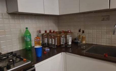 According to the police, a large number of Haryana-labelled alcohol bottles and hookahs among other things were recovered from the Supernova flat. ( @upuknews1/X)